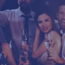 Stock image of young adults on a night out with Champagne flutes