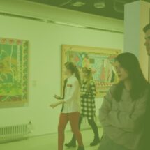 Stock image of young adults exploring an art museum
