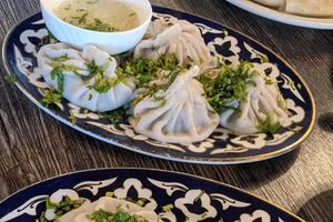 photo of a plate filled with four uzbek steamed dumplings called manti