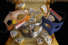Photo of Purim masks, a grogger, hamentaschen, and the Megillah