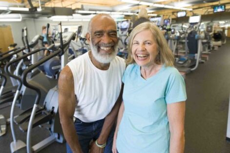 Image of two senior adults standing together at the gym