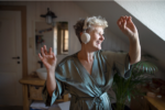Image of a senior adult dancing with headphones on
