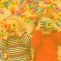 Stock image of two children playing with shape blocks