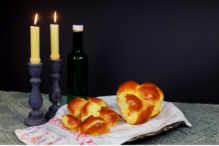 Stock image of Shabbat candles, wine, and challah