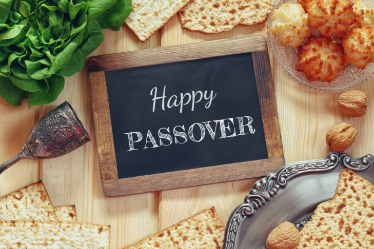 Photo of a happy Passover sign with Pesach food surrounding