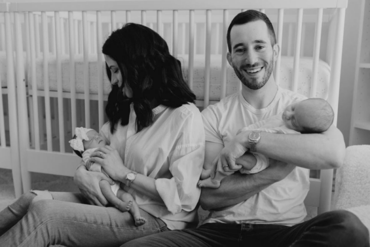 Photo of Alexa and Ian Sachs holding their two babies