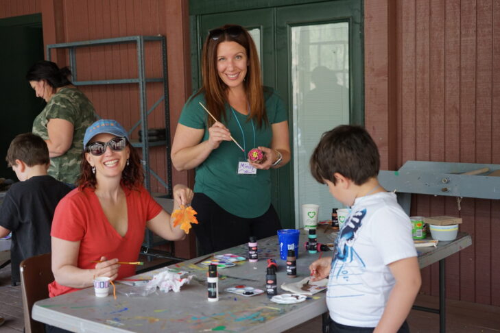Photo of participants at PJ Library Family Camp enjoying some art time