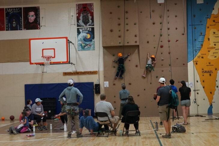 Photo of two young participates on the rock wall at PJ Library Family Camp