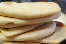 photo of a stack of homemade pita bread on a plate