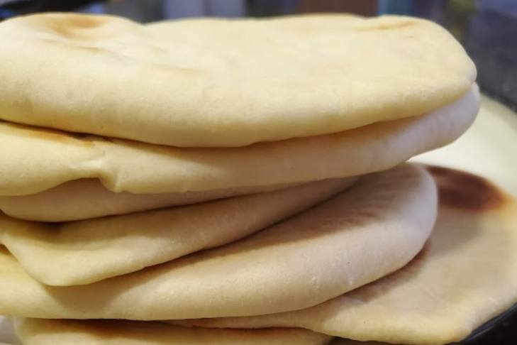 photo of a stack of homemade pita bread on a plate