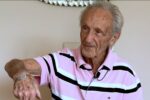 photo of Edward Mosberg, a Holocaust survivor, showing his numbered bracelet