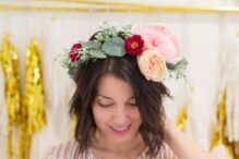 photo of a woman wearing a flower crown featuring a variety of faux flowers and greenery
