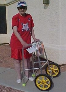 Image of an elderly woman using a modified walker.