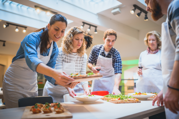 Stock image of a group adults in a cooking class