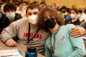 Two teens sit together at youth group convention