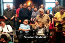 Image of a group of Gesher participants posing for a photo at Simchat Shabbat - the words Simchat Shabbat appear centered toward the bottom of the screen