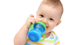 Image of a young child drinking from a sippy cup