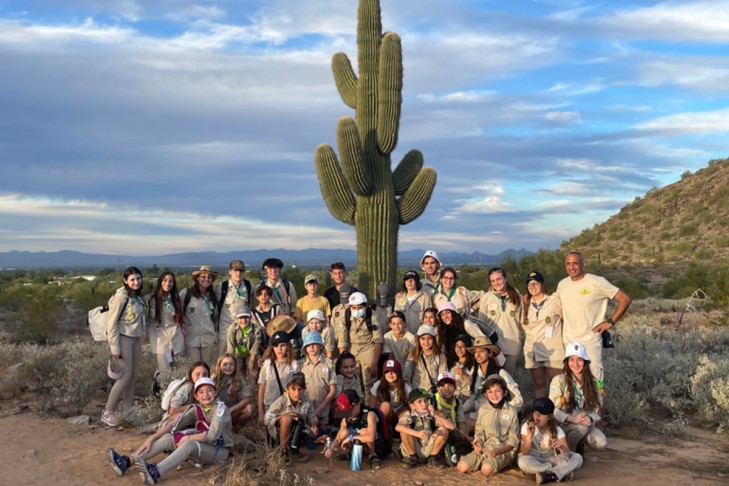 Image of a group of Shevet Shemesh participants posing for a photo in their uniforms in the desert