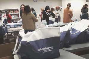 Photo of bags being filled with hygiene products for Dignity Grows, a project of Women IN Philanthropy
