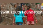 Image of two girls walking through the woods with the words "Swift Youth Foundation" and "Fun is just the start" as an overlay.