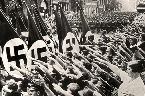 Citizens salute Hitler while attending a Nazi parade in Nuremberg, Germany, 1937.