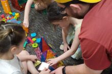 photo of kindergartners at camp building together with magnatiles