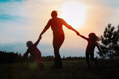 happy mother with kids play in nature, family enjoy sunset